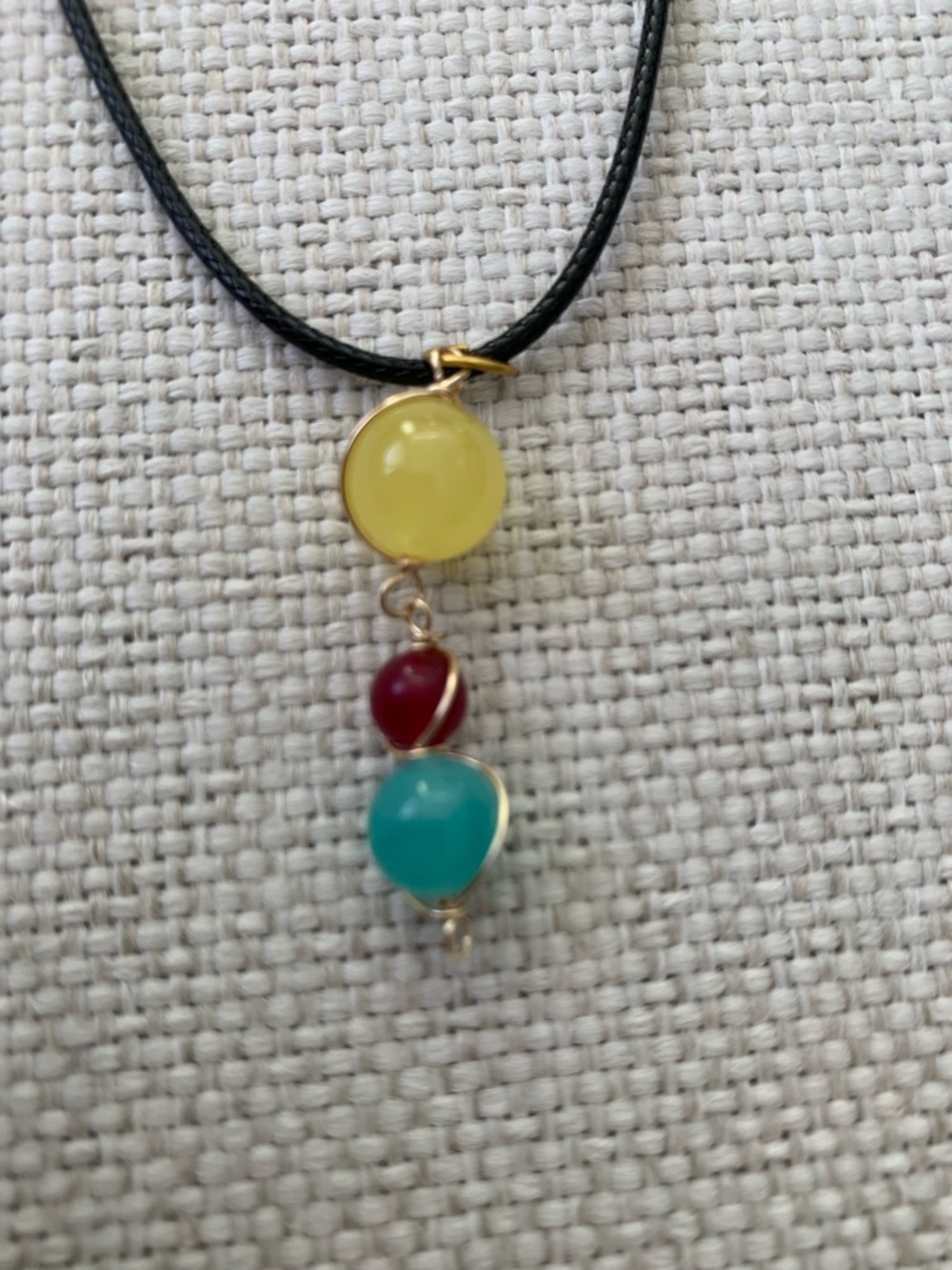 Beaded Round Pendant Necklace with Black Cord, Yellow Red Blue Glass Beads